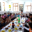 Kids sit around a long table full of food